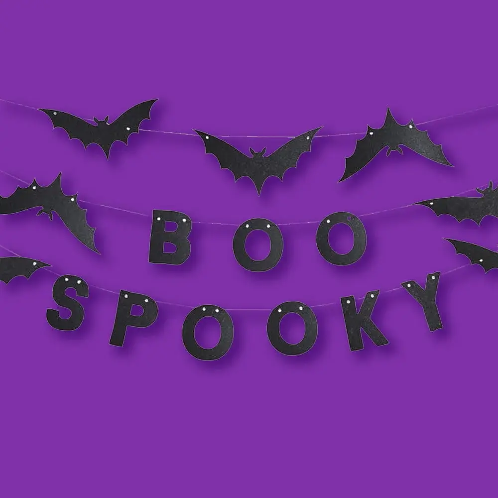 Black Spooky Halloween banner with bat-shaped decorations hanging against a purple background.