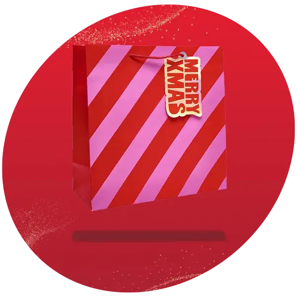 Red and pink striped gift bag with a bold tag that reads Merry Xmas, displayed on a red background with a festive design.