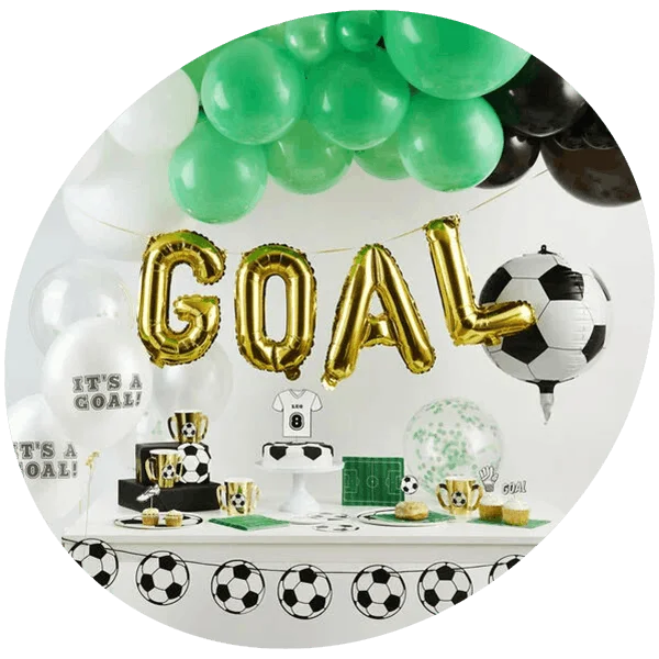 Football-themed kids party setup with green balloons, goal letter balloons, football decorations, and matching tableware on display