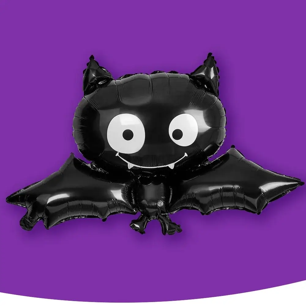 A black bat-shaped balloon with large eyes and a small fanged smile, set against a purple background