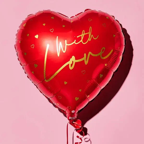 A shiny red heart‑shaped balloon with gold lettering that reads With Love against a pink background.