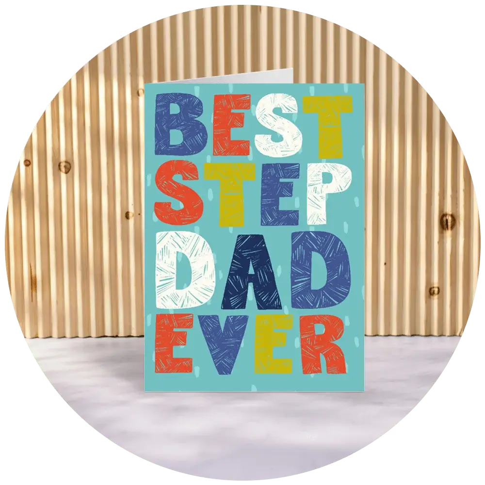 A greeting card with the text 'BEST STEP DAD EVER' in large, colorful letters. The background of the card is light blue with subtle patterns, and it is standing on a surface with a wooden panel backdrop. A greeting card with the text 'BEST STEP DAD EVER' in large, colorful letters. The background of the card is light blue with subtle patterns, and it is standing on a surface with a wooden panel backdrop.