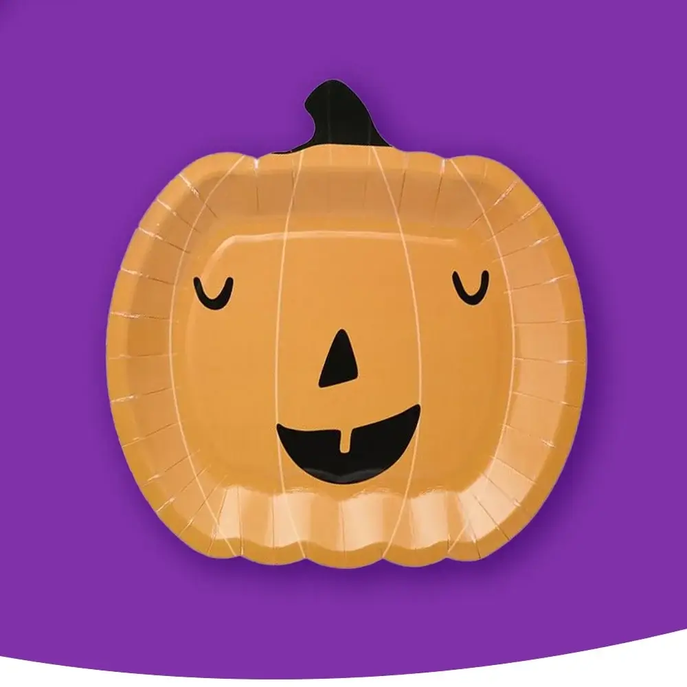 A pumpkin-shaped paper plate with a cheerful jack-o'-lantern face, set against a purple background