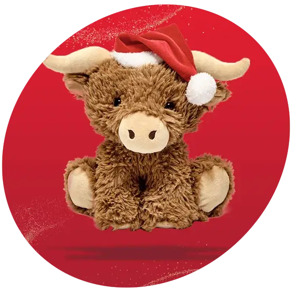 Brown plush Highland cow toy wearing a red Santa hat with a white pom-pom, set against a red background with a glitter effect.