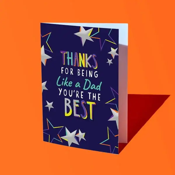 A navy blue Fathers Day card with colourful lettering reading Thanks for being like a dad you’re the best, decorated with star illustrations and displayed against a bright orange background.