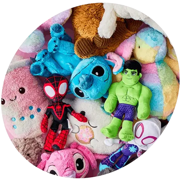 Selection of colourful plush toys including Stitch, Hulk, Spider-Man, Ghost-Spider, teddy bears, and pastel animal soft toys arranged on a pink background.