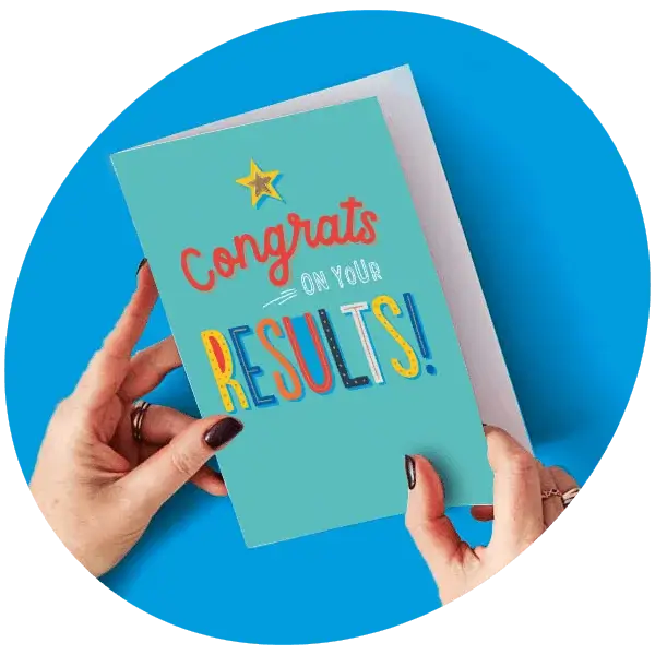 Congrats on Your Results greeting card held in hands against a blue background.