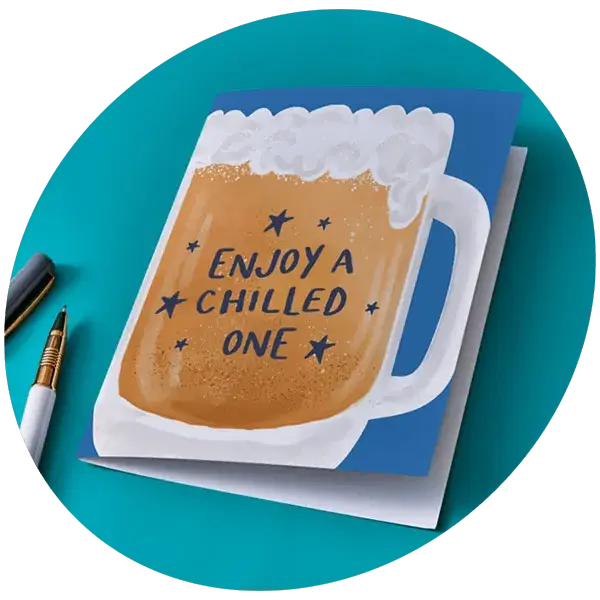 Beer mug shaped greeting card with frothy top and text Enjoy a chilled one on a blue background