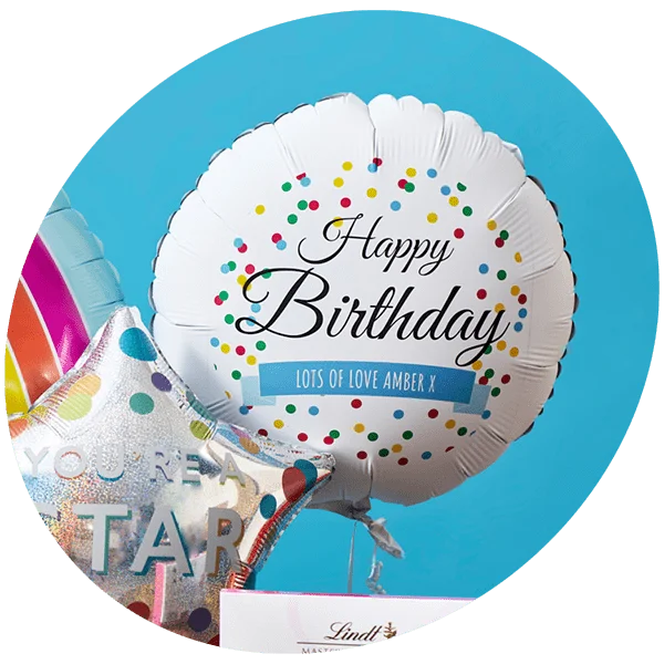 Round white balloon with colorful polka dots and the text Happy Birthday in black script, featuring a blue ribbon banner with Lots of Love Amber x, next to a silver star-shaped balloon with rainbow accents and partially visible text You're a Star, set against a light blue background.