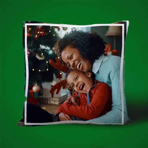 Personalised cushion featuring a Highland cow illustration and custom family name, displayed against a green background.