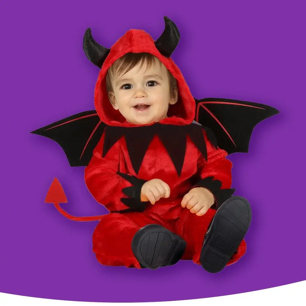 A baby in a red devil costume with black horns, wings, and a tail, sitting against a purple background