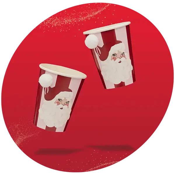 Two red and white striped paper cups featuring Santa Claus illustrations with pom-pom details, set against a red background with a glitter effect.