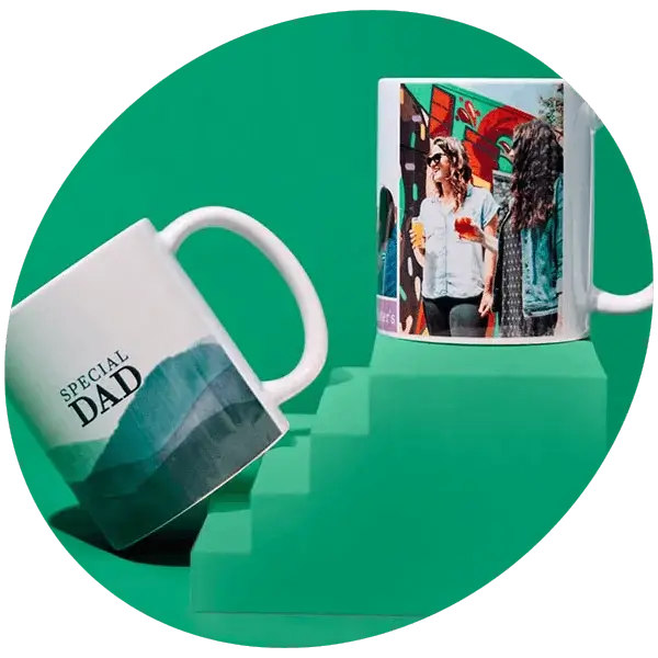 Personalised photo mugs displayed on green podium blocks, including a Special Dad mug and a custom photo mug.