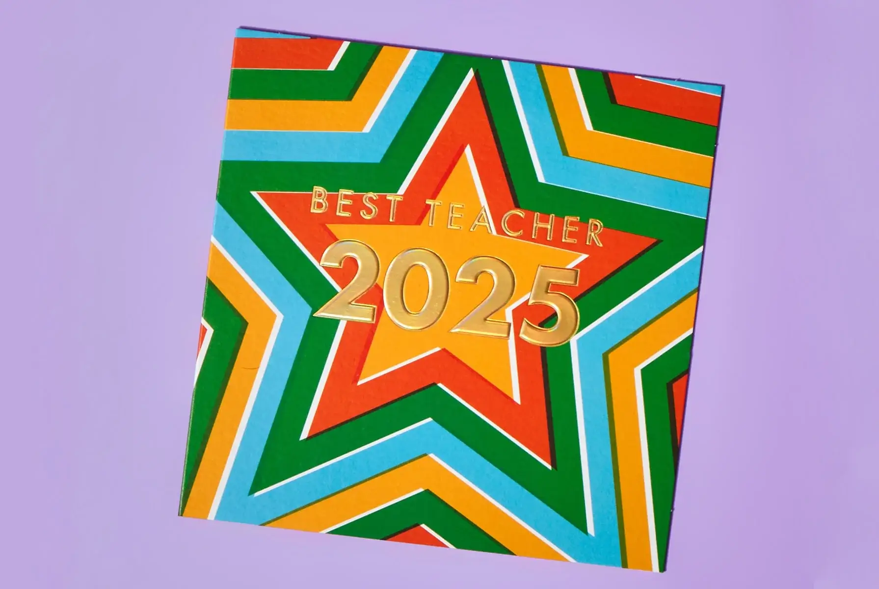 'A colorful card with a star pattern and the text 'BEST TEACHER 2025' in gold letters on a purple background.' 'A colorful card with a star pattern and the text 'BEST TEACHER 2025' in gold letters on a purple background.'