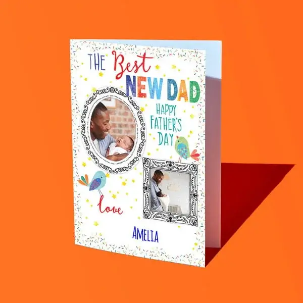 A personalised Fathers Day card reading The Best New Dad Happy Father’s Day, featuring two framed photos, colourful confetti details, and a name at the bottom, displayed against a bright orange background.