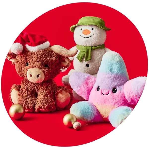 Plush purple bunny and small fairy doll in a pink dress with wings, lying on a pink background.